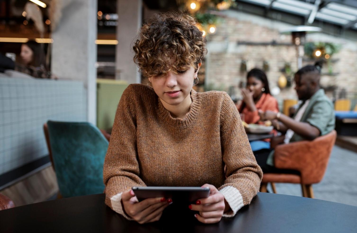 Small business owner analyzing financial reports with calculator and charts