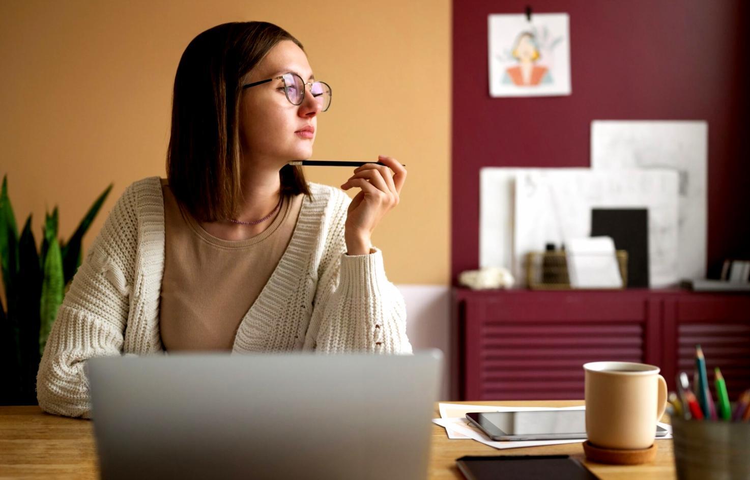 Business meeting with financial documents and laptop showing budget spreadsheets
